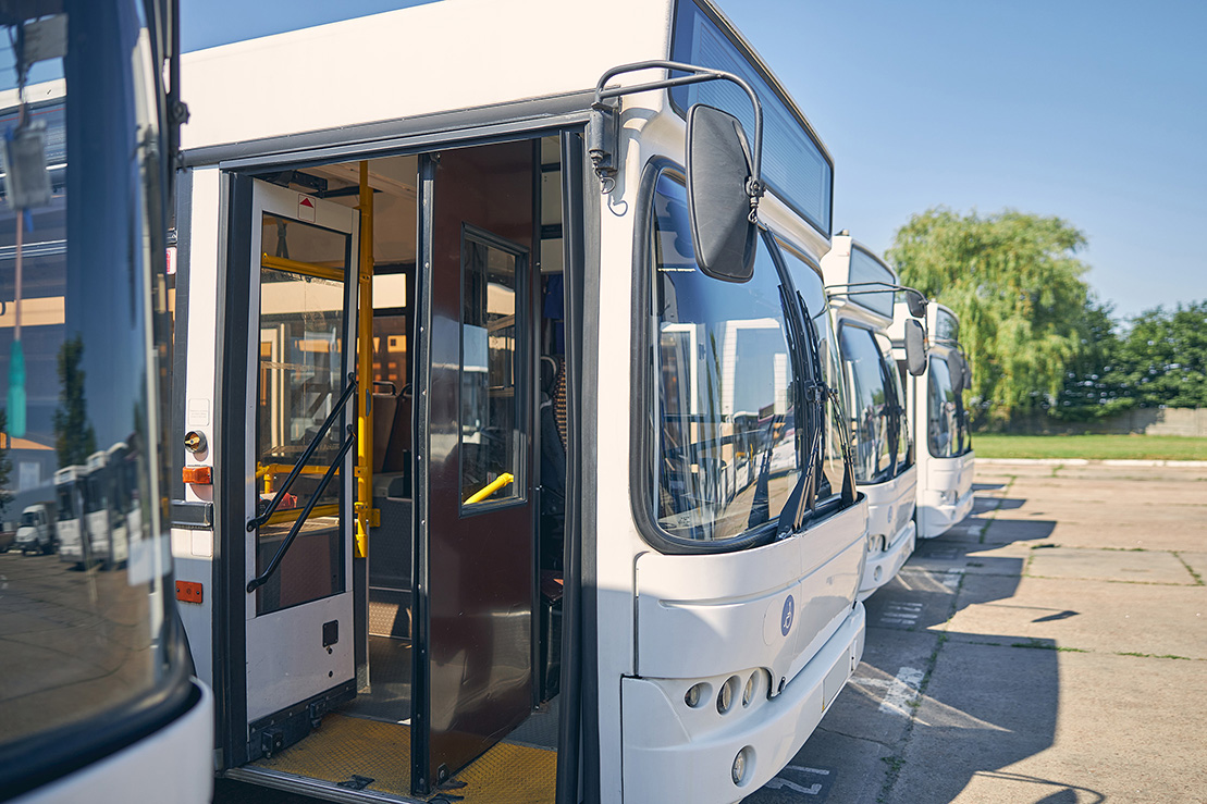 Close up of white bus with opened doors