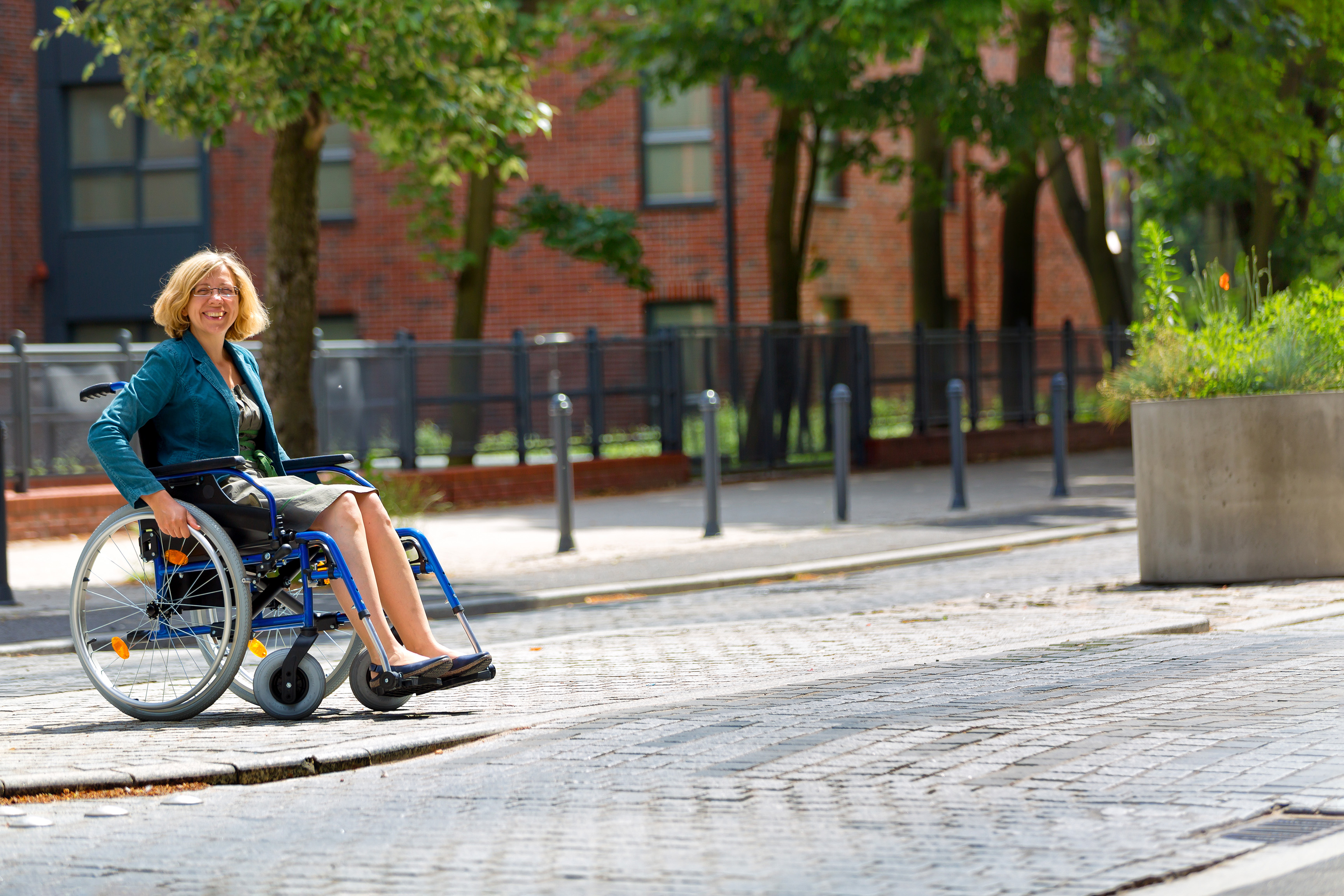 Women in Wheelchair in a street environment