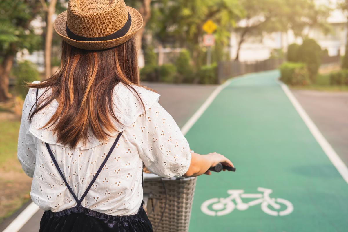 young woman riding bicycle on bike lane