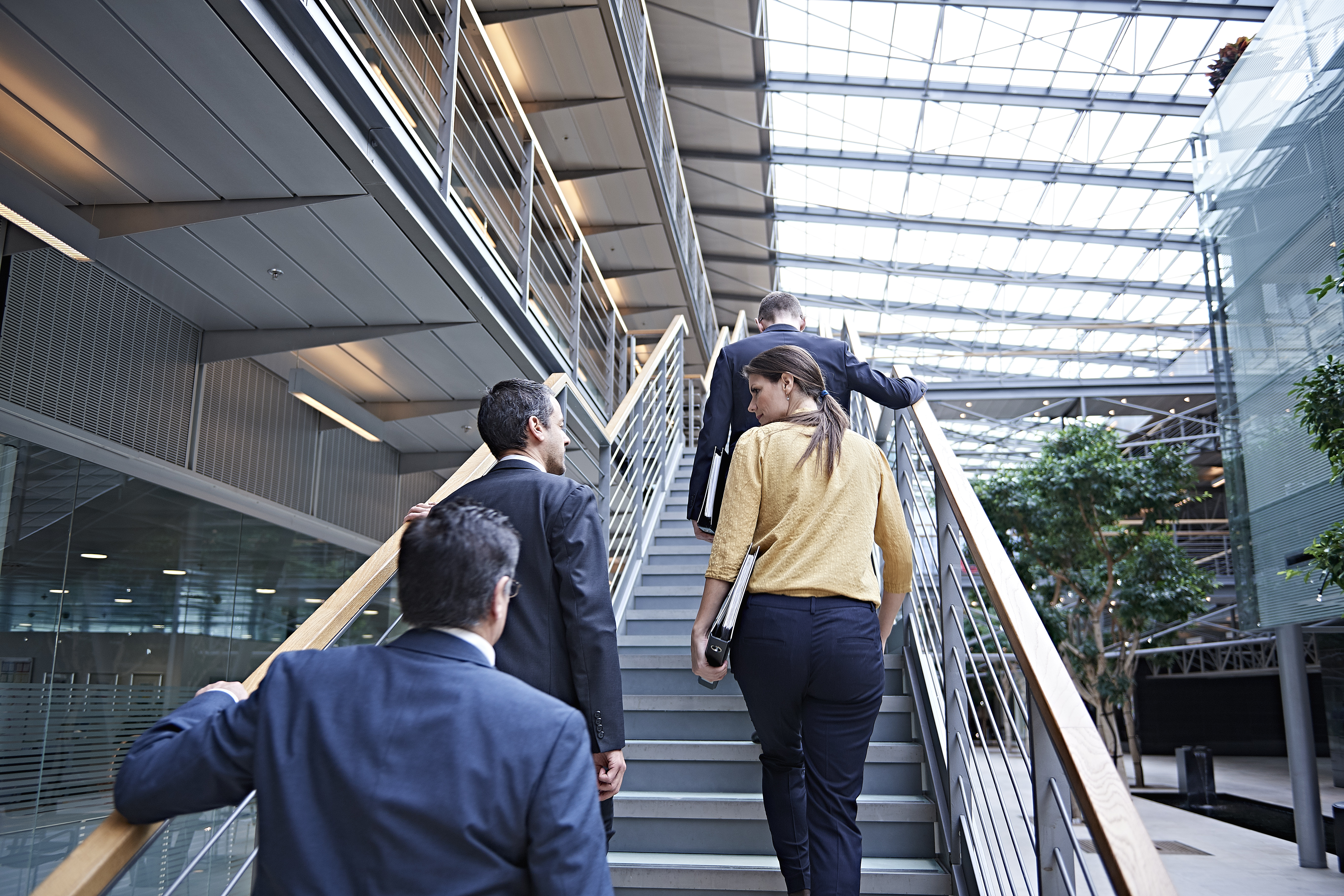 Group of People Walking Upstairs in a Building
