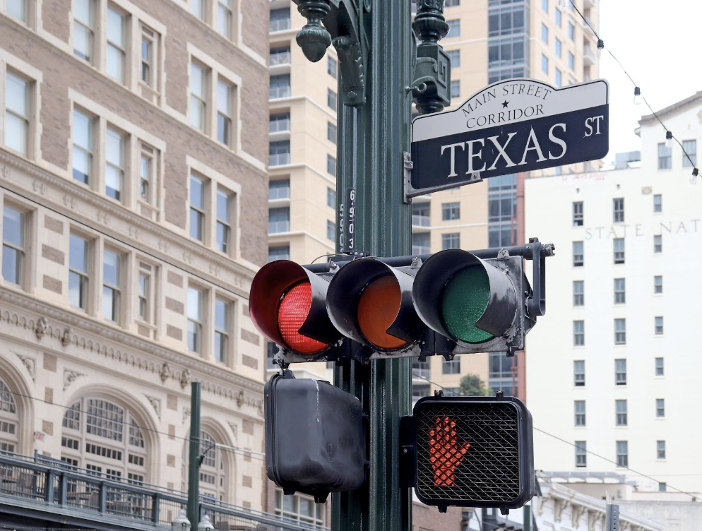 Texas Street Sign With A Traffic Light And Crosswalk