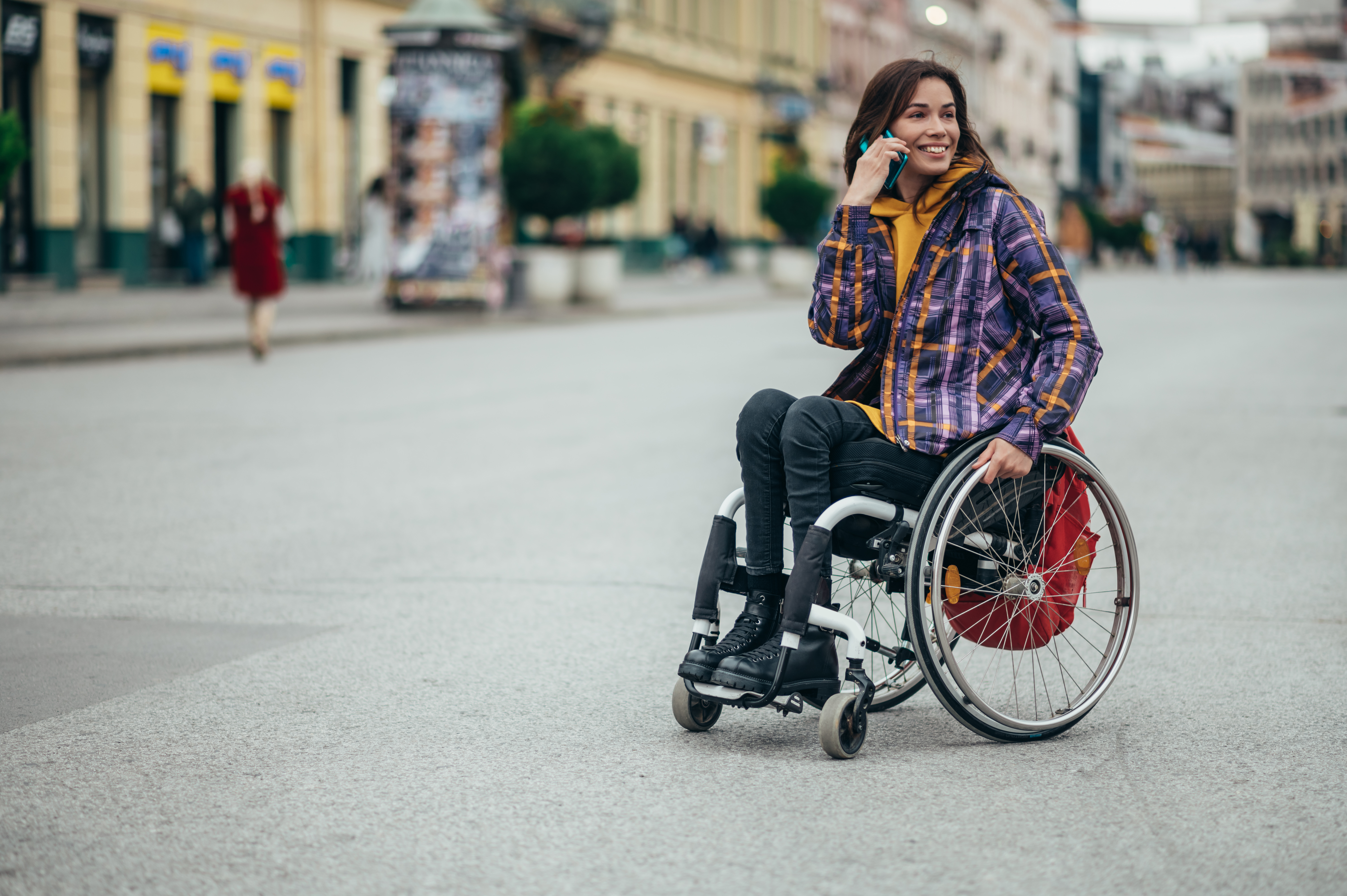 Woman with disability using a smartphone while out in the city